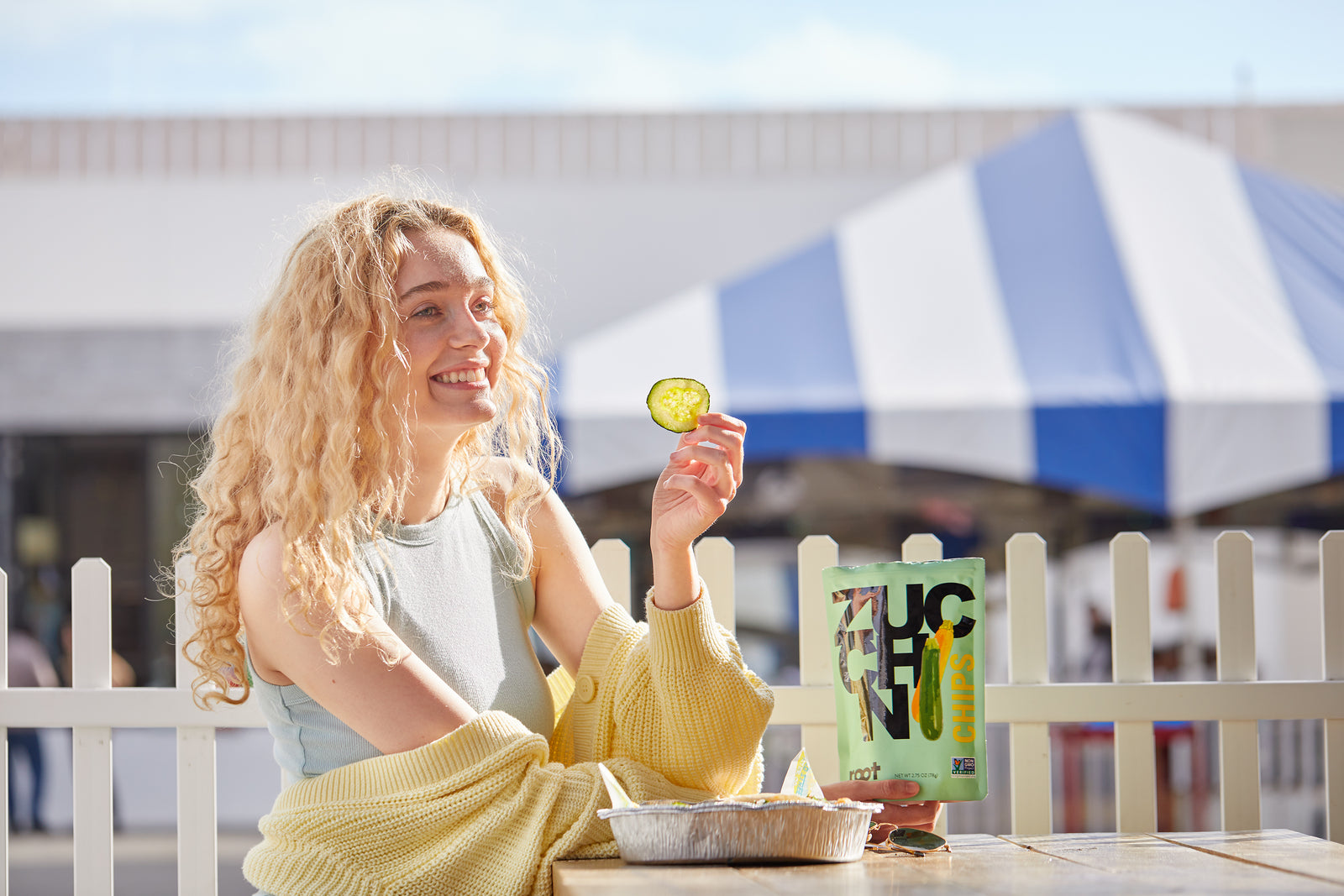 girl eating root chips zucchini flavor